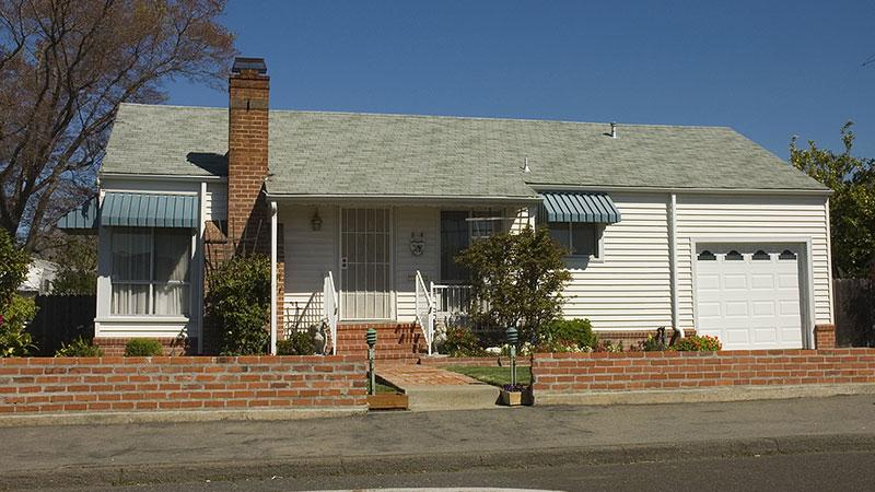 Front view of an older home with a brick chimney