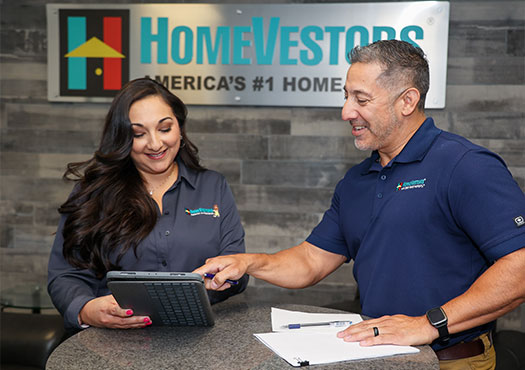 HomeVestors franchisee being shown financing options by mentor